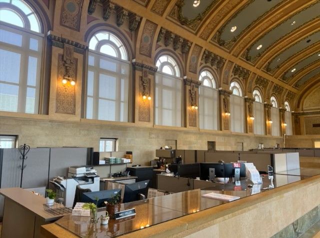 A large room with lots of windows and cubicles