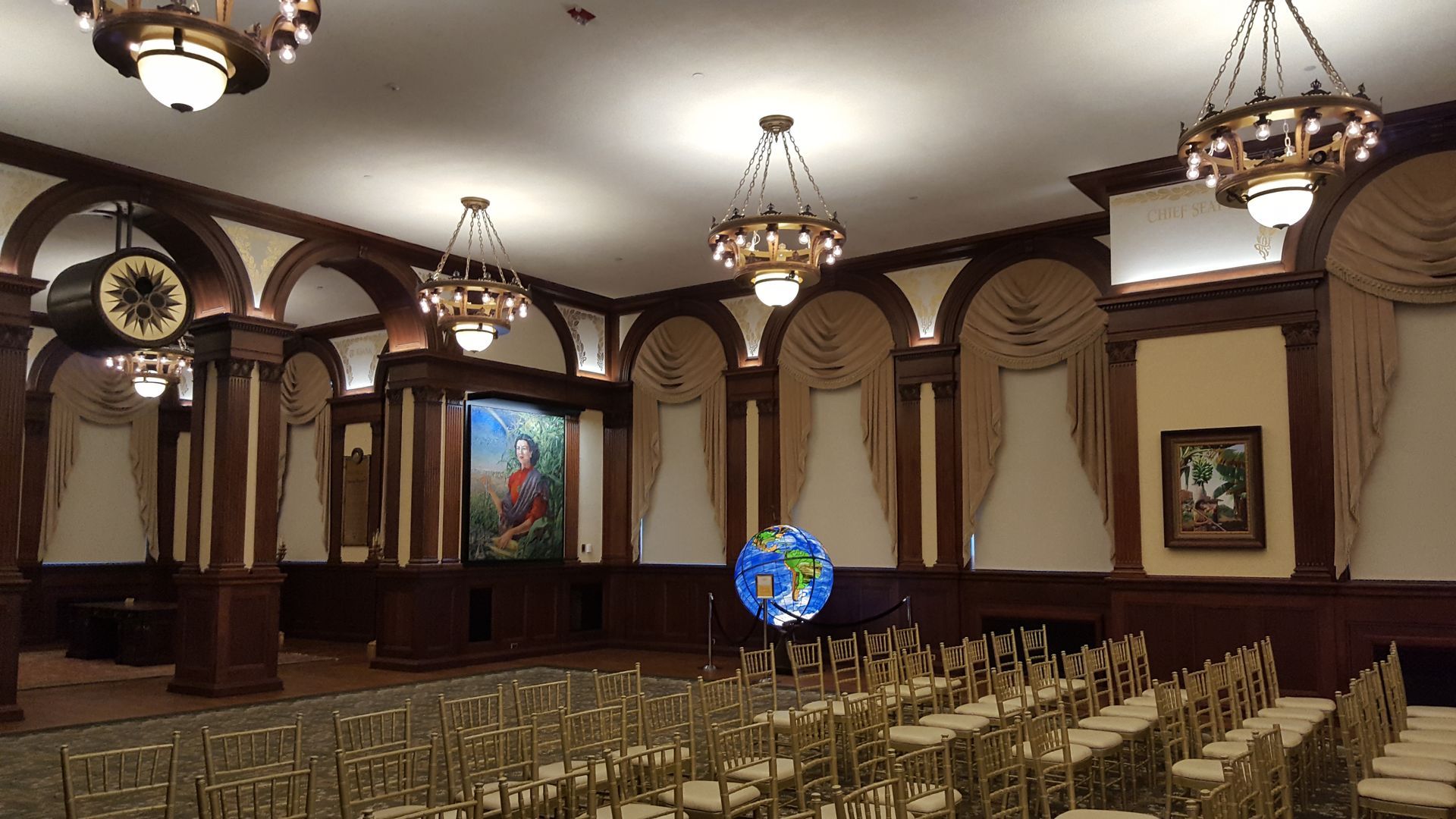 A large room with rows of chairs and a clock on the wall.
