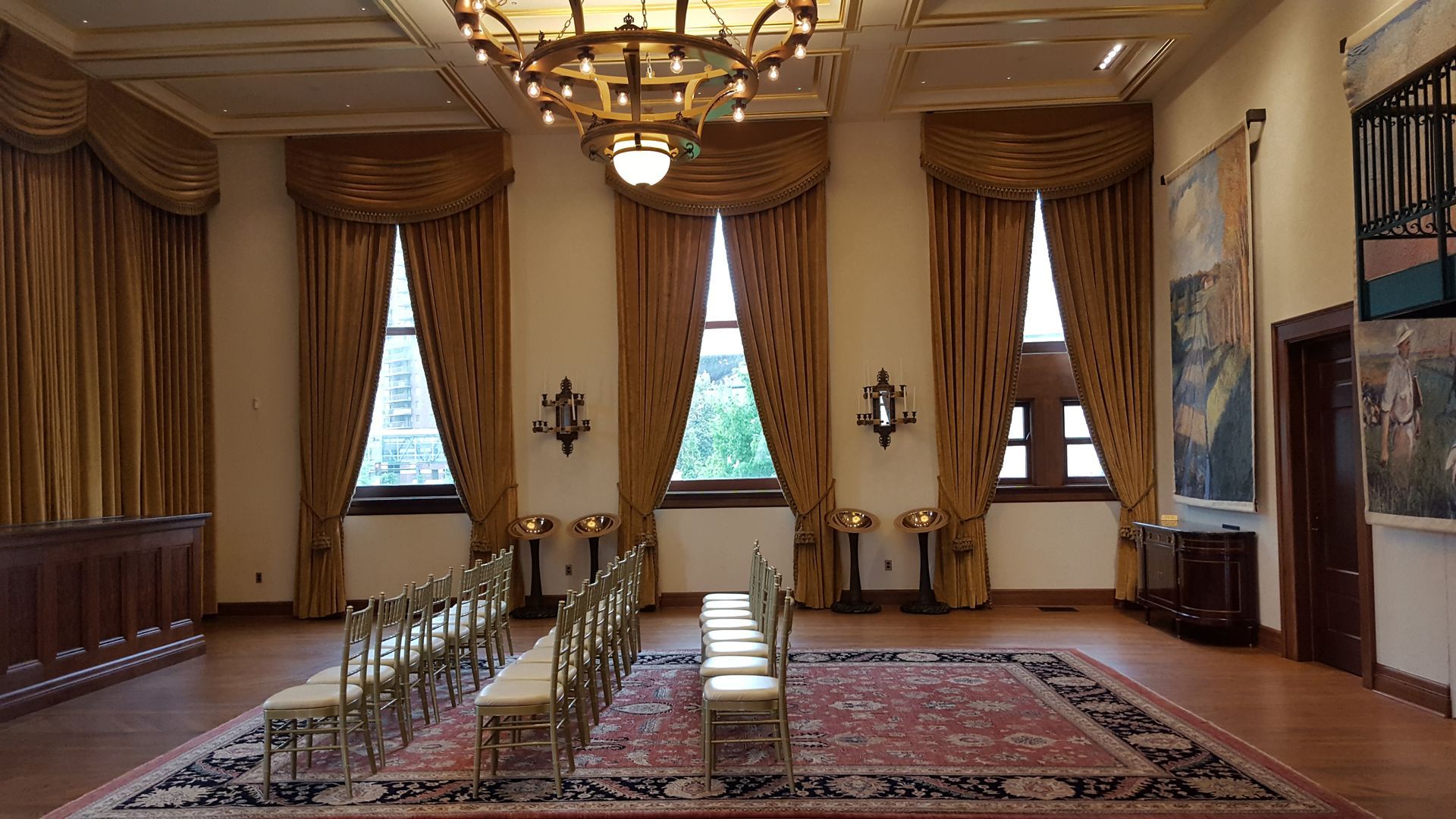 A large room with rows of chairs and a chandelier.