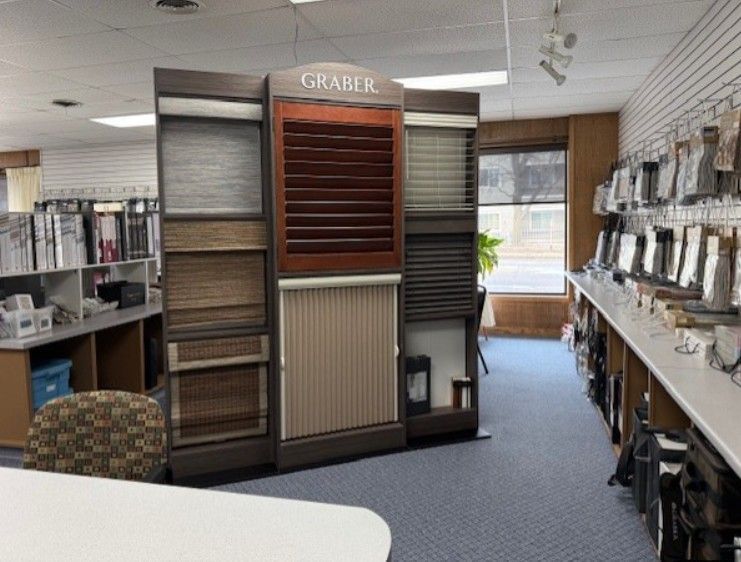 a display of window blinds in a showroom, with varying styles and colors