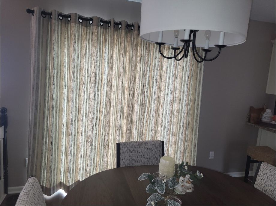 A dining room with a table and chairs and a chandelier