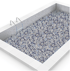 Rectangular swimming pool filled with blue, gray, and white stone aggregate, with metal ladder.