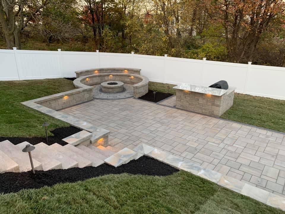 There is a fire pit in the middle of the patio.