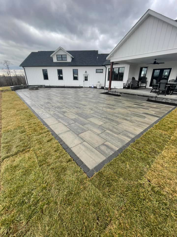 A large white house with a patio in front of it.
