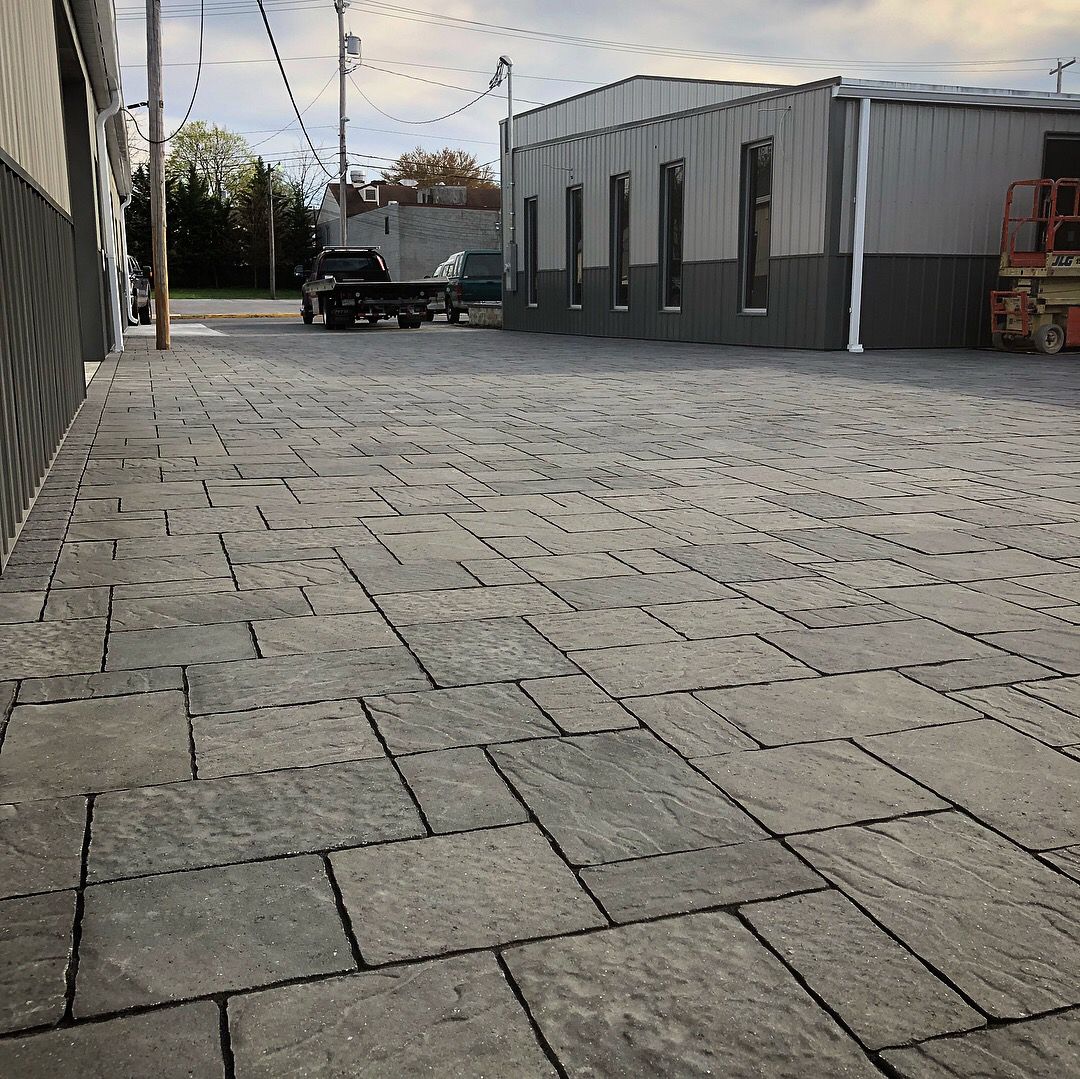 A parking lot with a truck parked in front of a building.