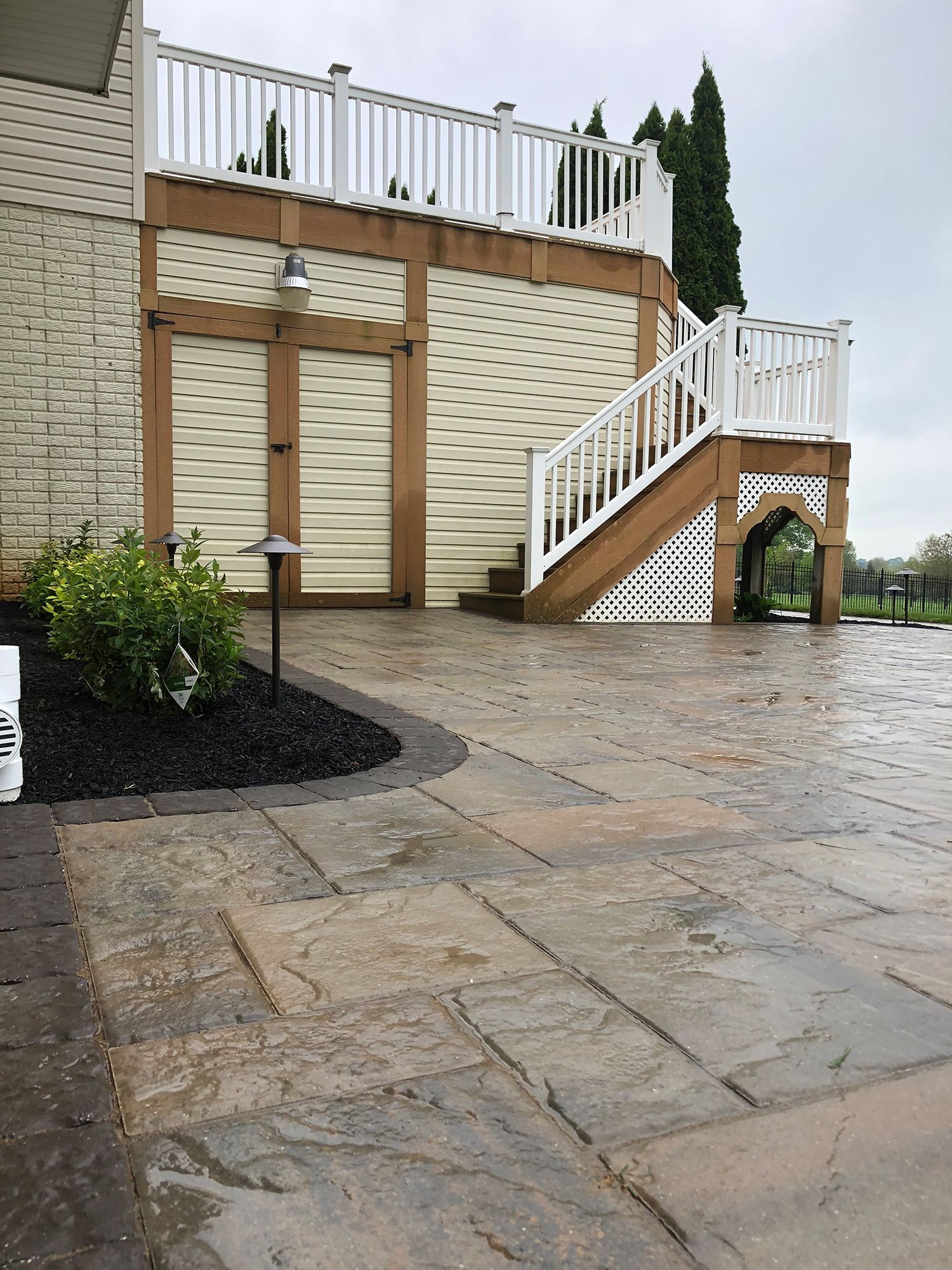 A house with a large deck and stairs leading up to it.