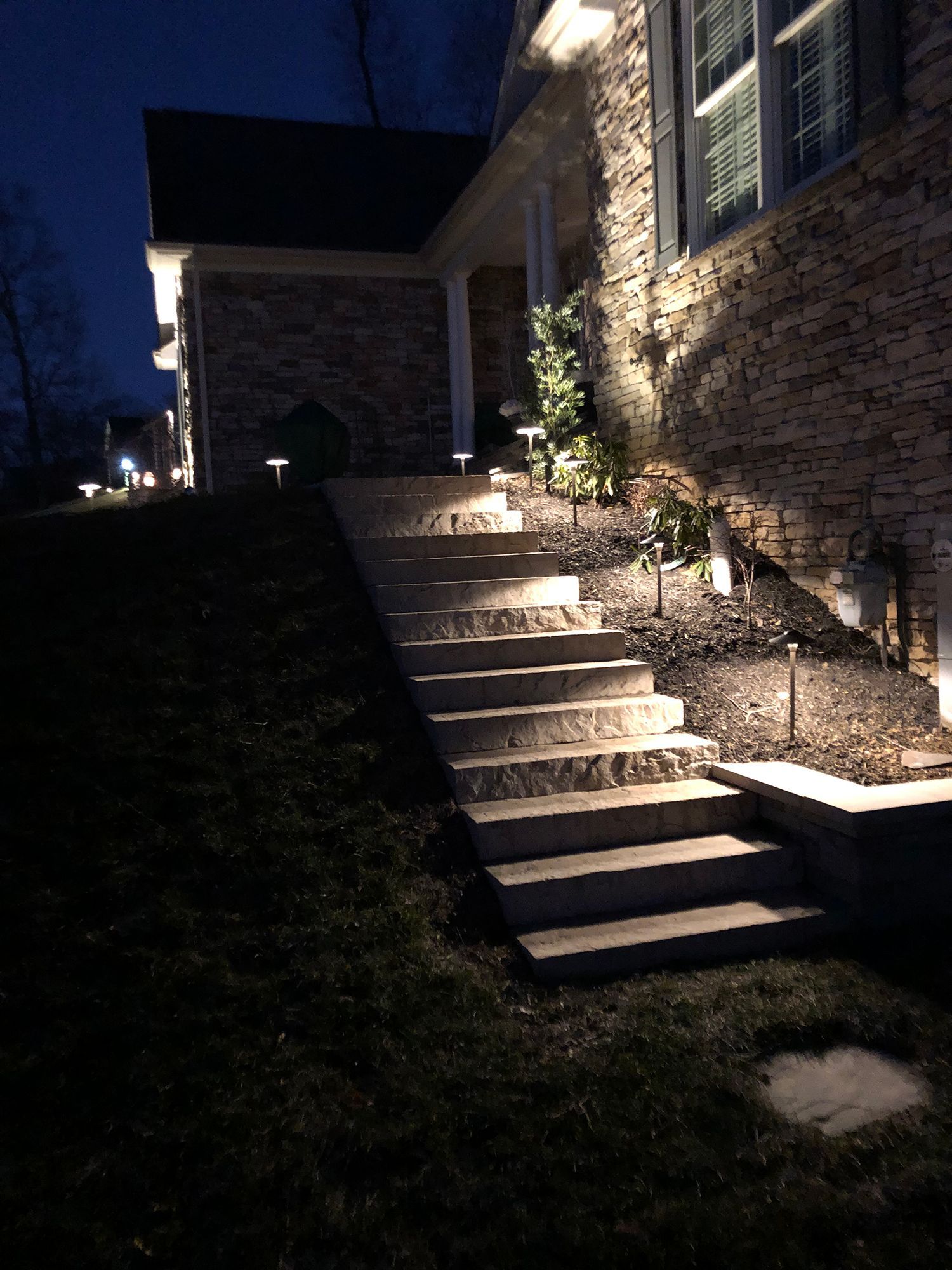 A set of stairs leading up to a house at night.