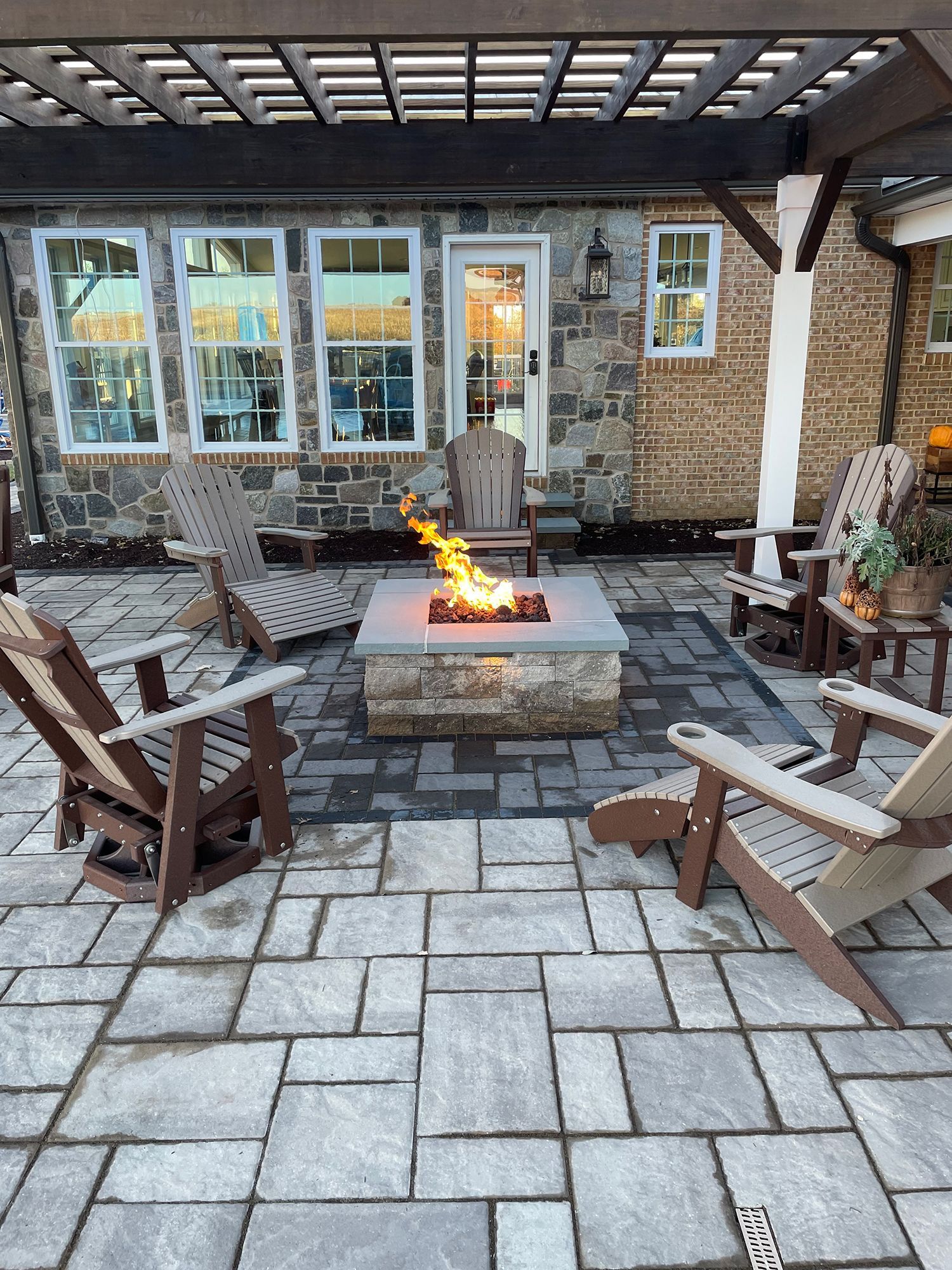 There is a fire pit in the middle of the patio.