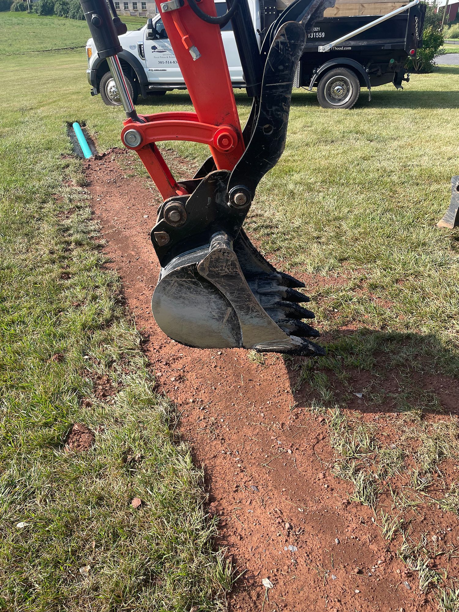 A bulldozer is digging a hole in the dirt in a field.