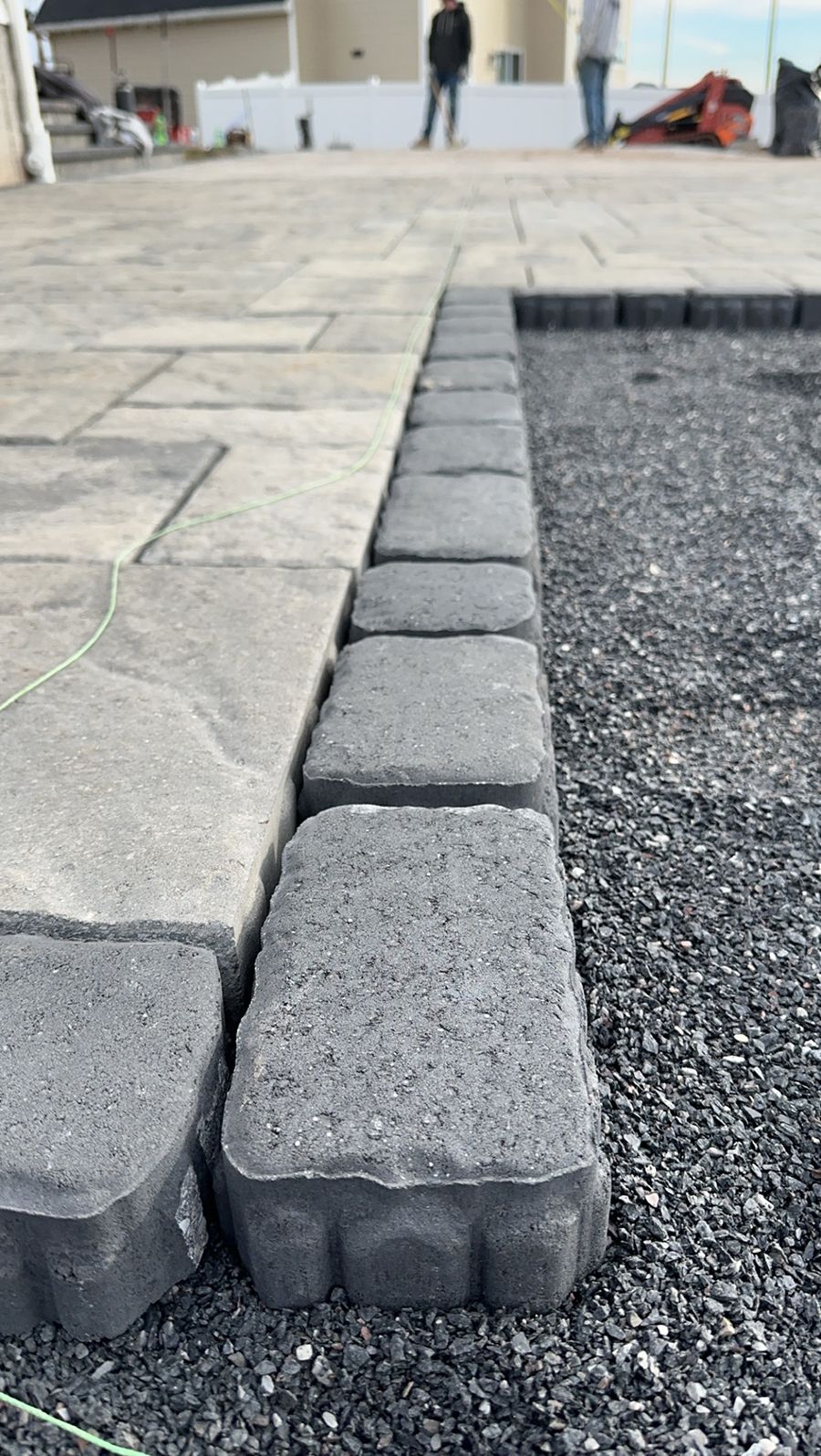 A row of bricks sitting on top of a pile of gravel.