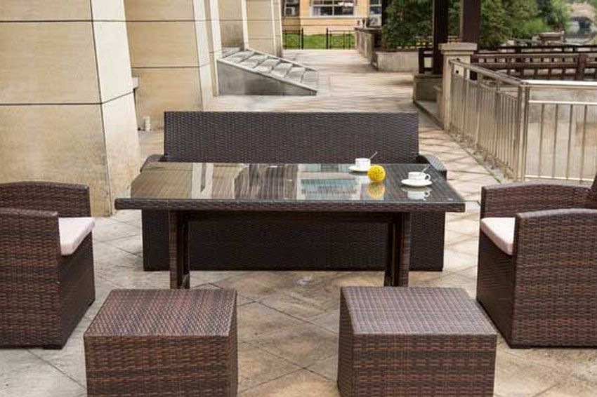 A wicker patio set with a table and chairs