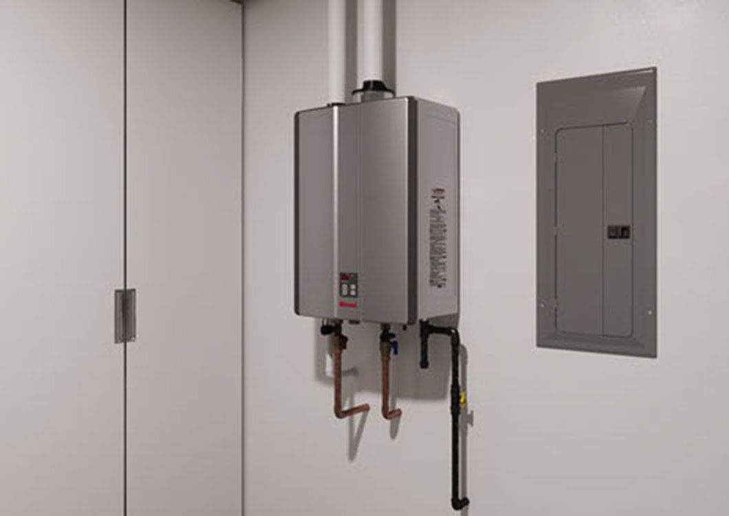Wall-mounted gas water heater with pipes in a utility room next to a breaker panel.