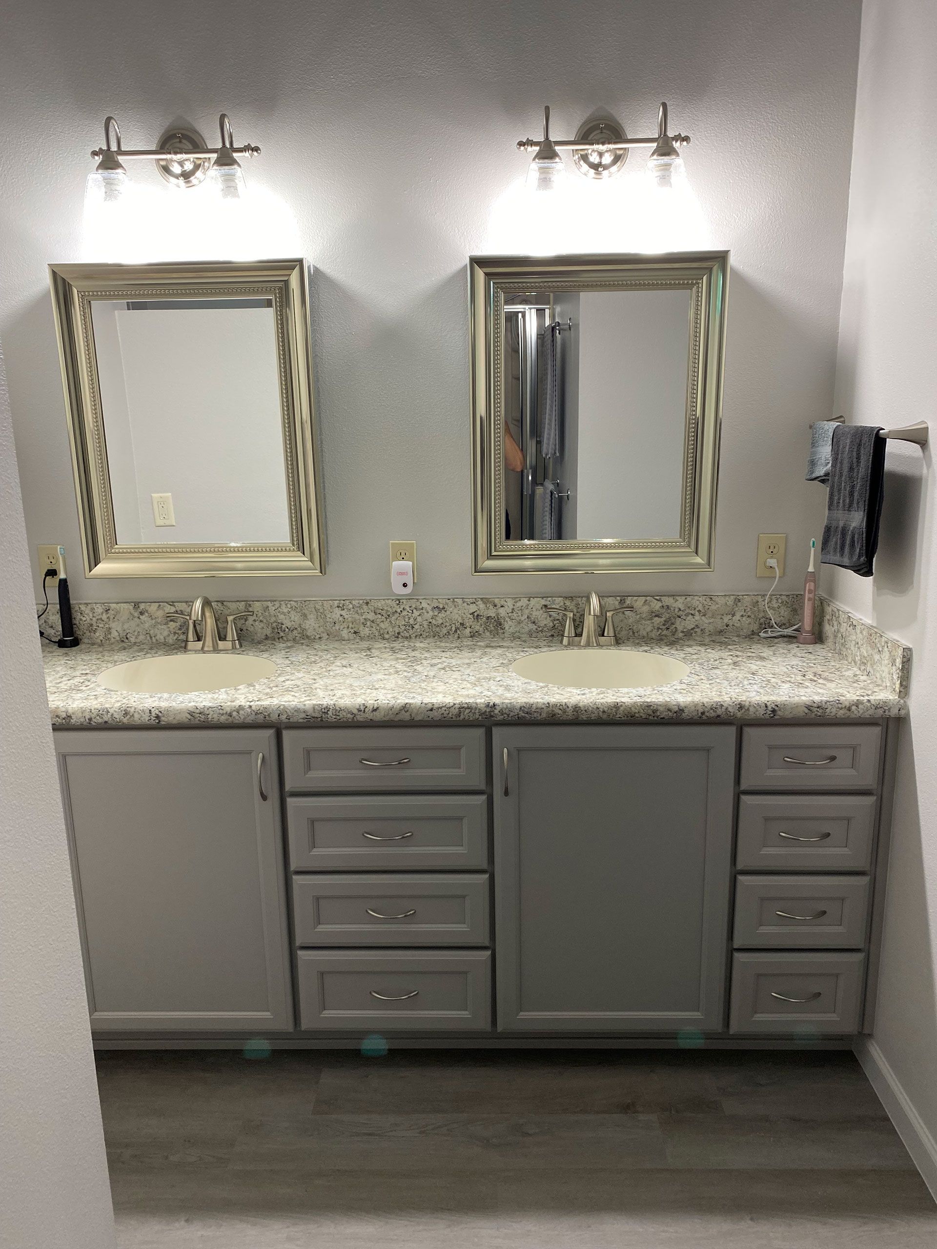 A bathroom with two sinks and two mirrors