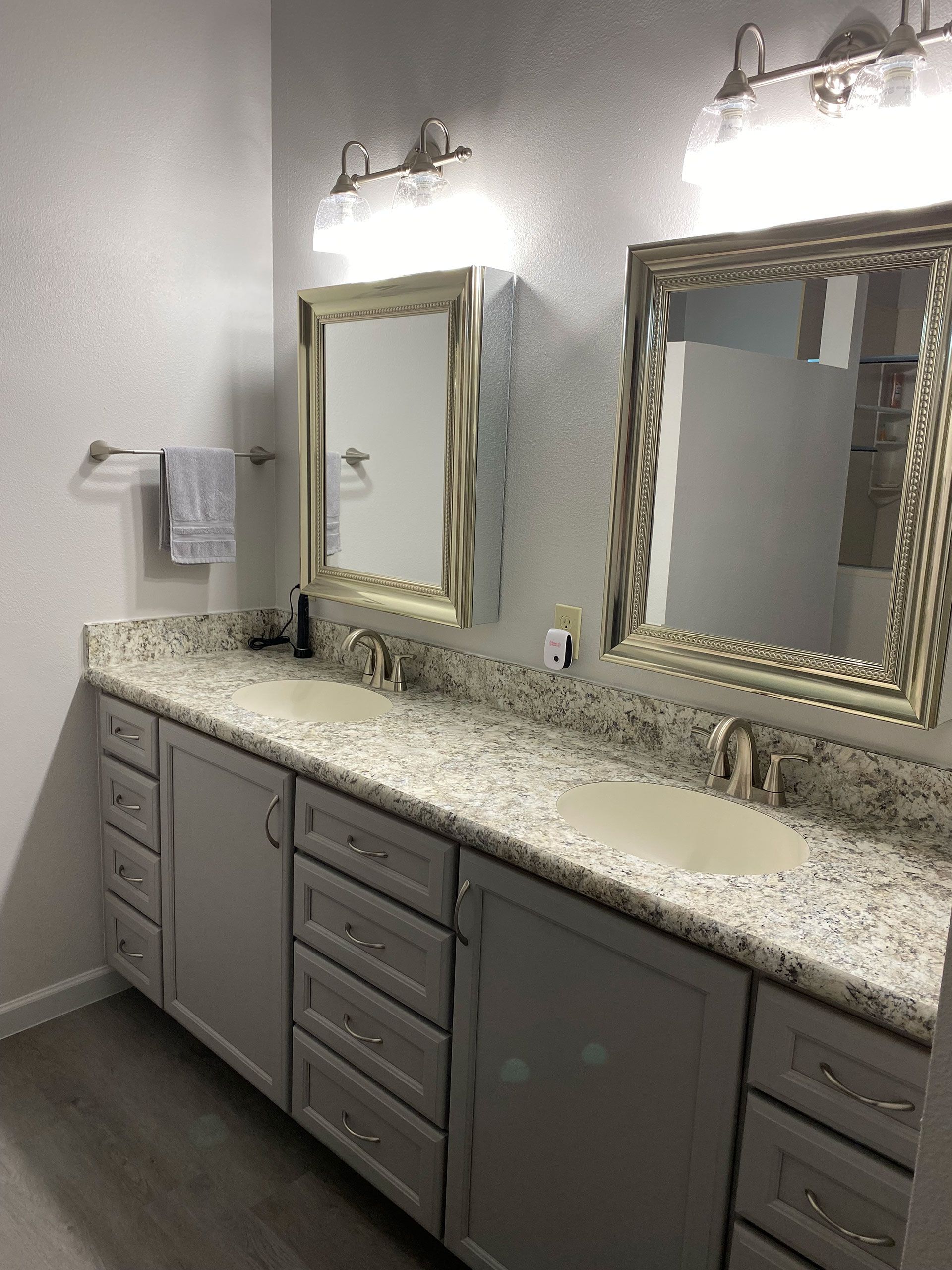 A bathroom with two sinks and two mirrors