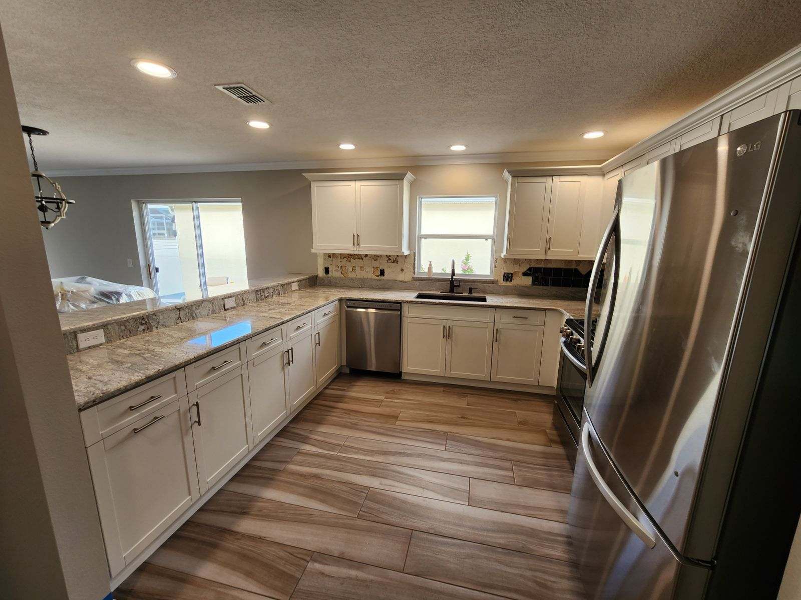 A kitchen with stainless steel appliances and white cabinets