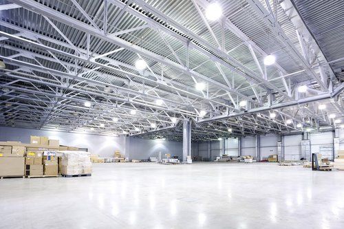 A large warehouse filled with lots of boxes and lights.