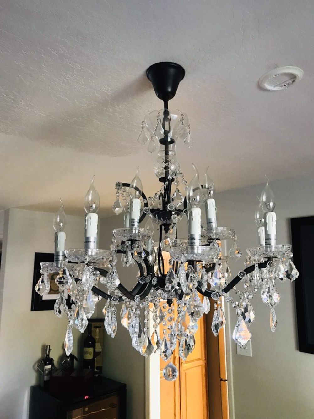 A chandelier is hanging from the ceiling in a living room