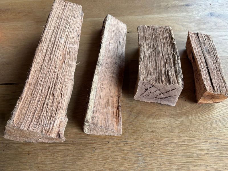 Four rectangular wood chunks on a wooden surface; various sizes and wood grain patterns.