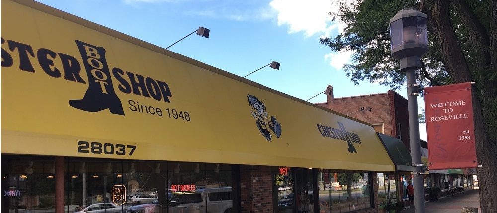 A store front with a yellow awning and the number 28037 on it