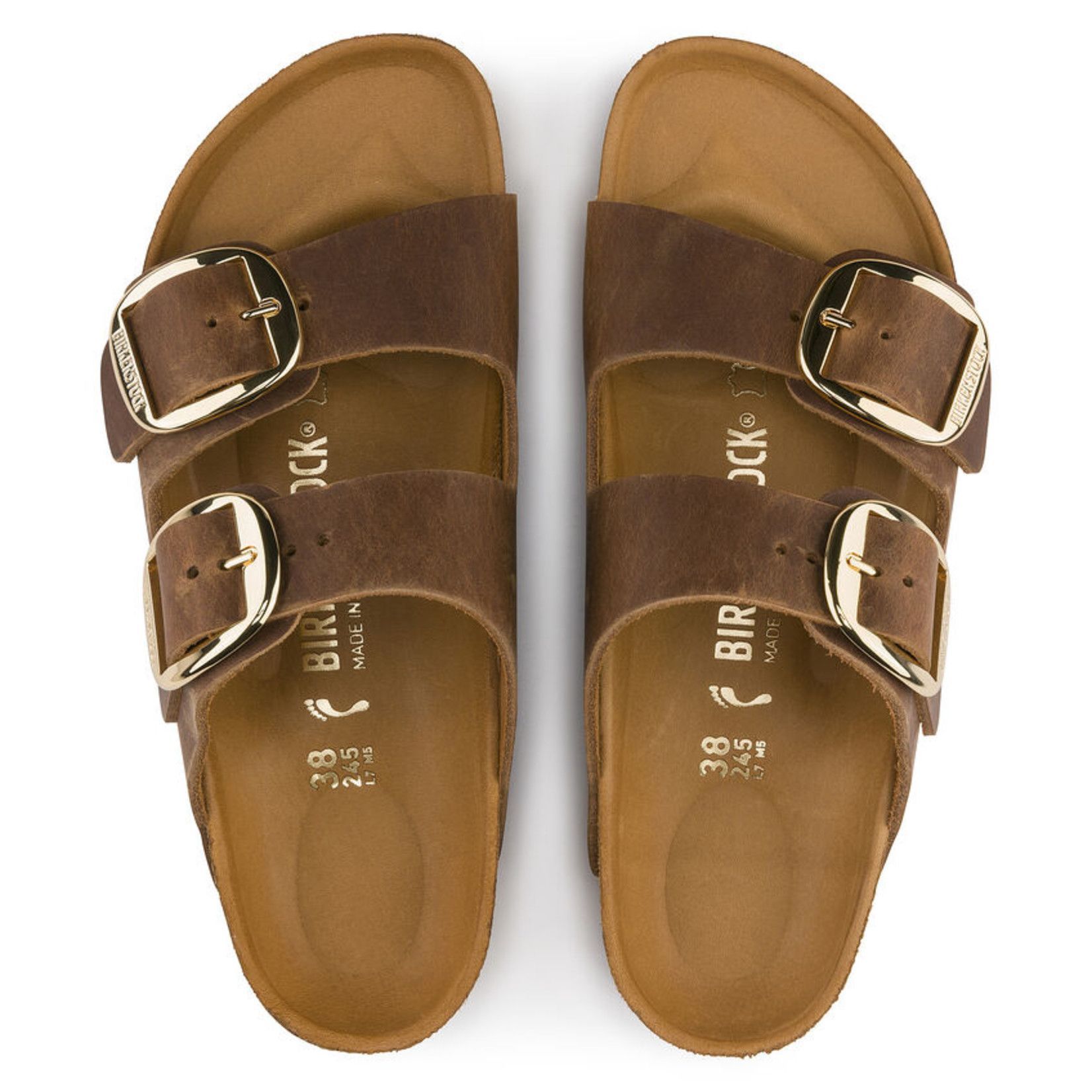 A pair of brown birkenstock sandals with gold buckles