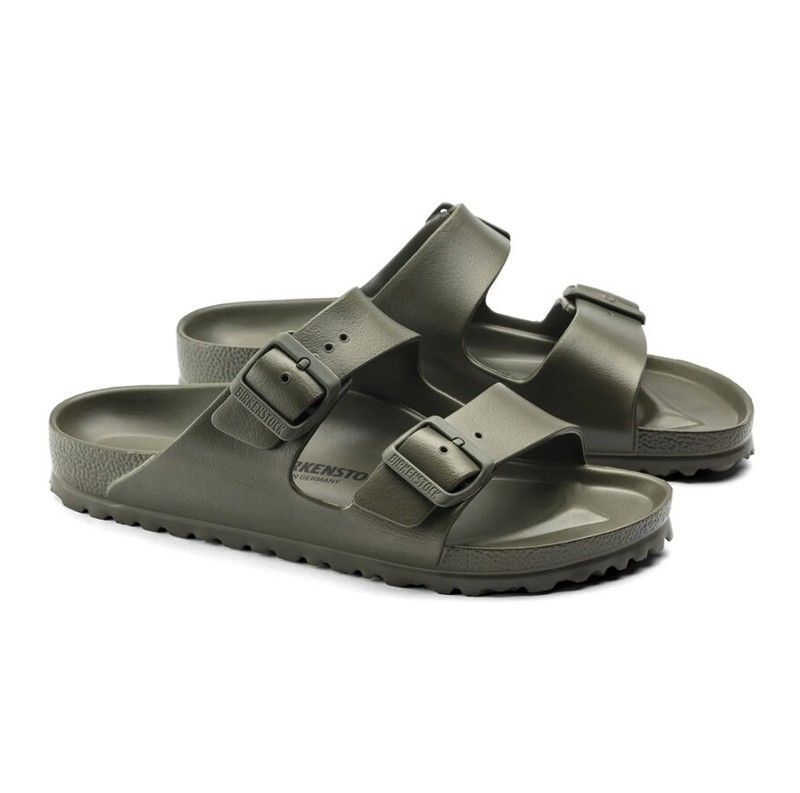 A pair of green birkenstock sandals on a white background.