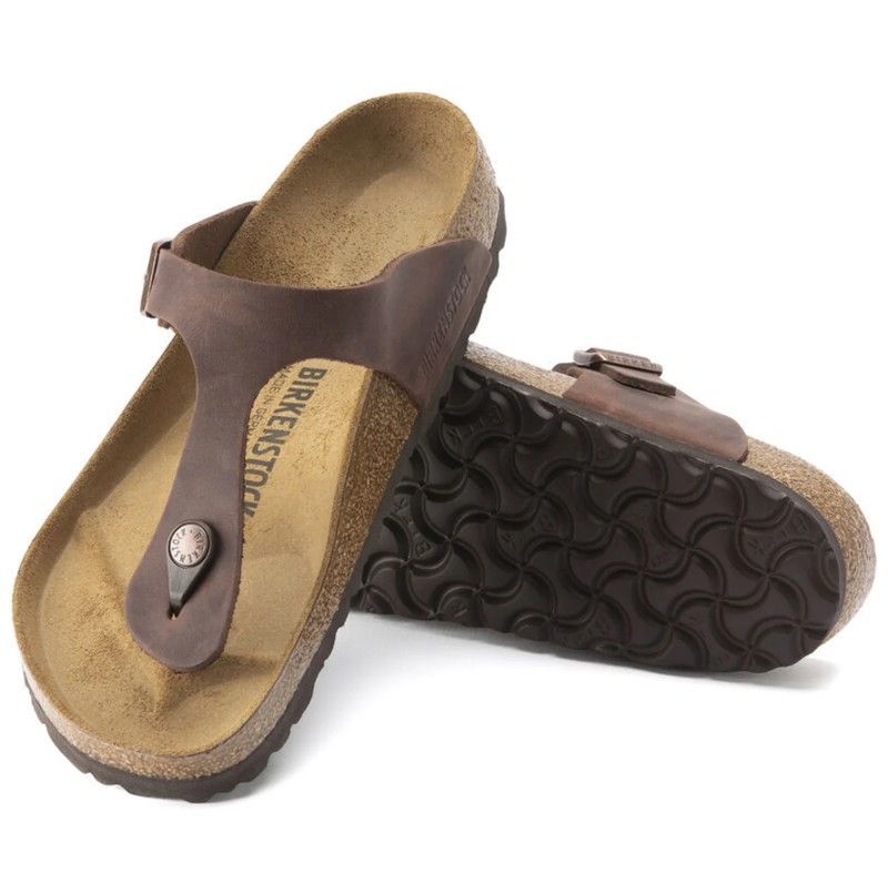 A pair of brown birkenstock sandals on a white background