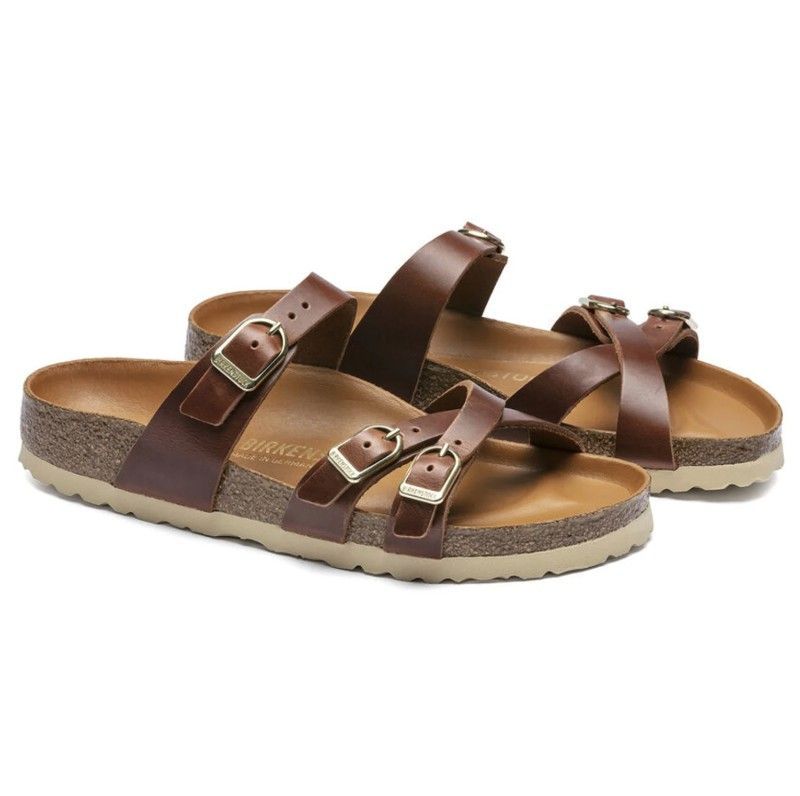 A pair of brown birkenstock sandals on a white background