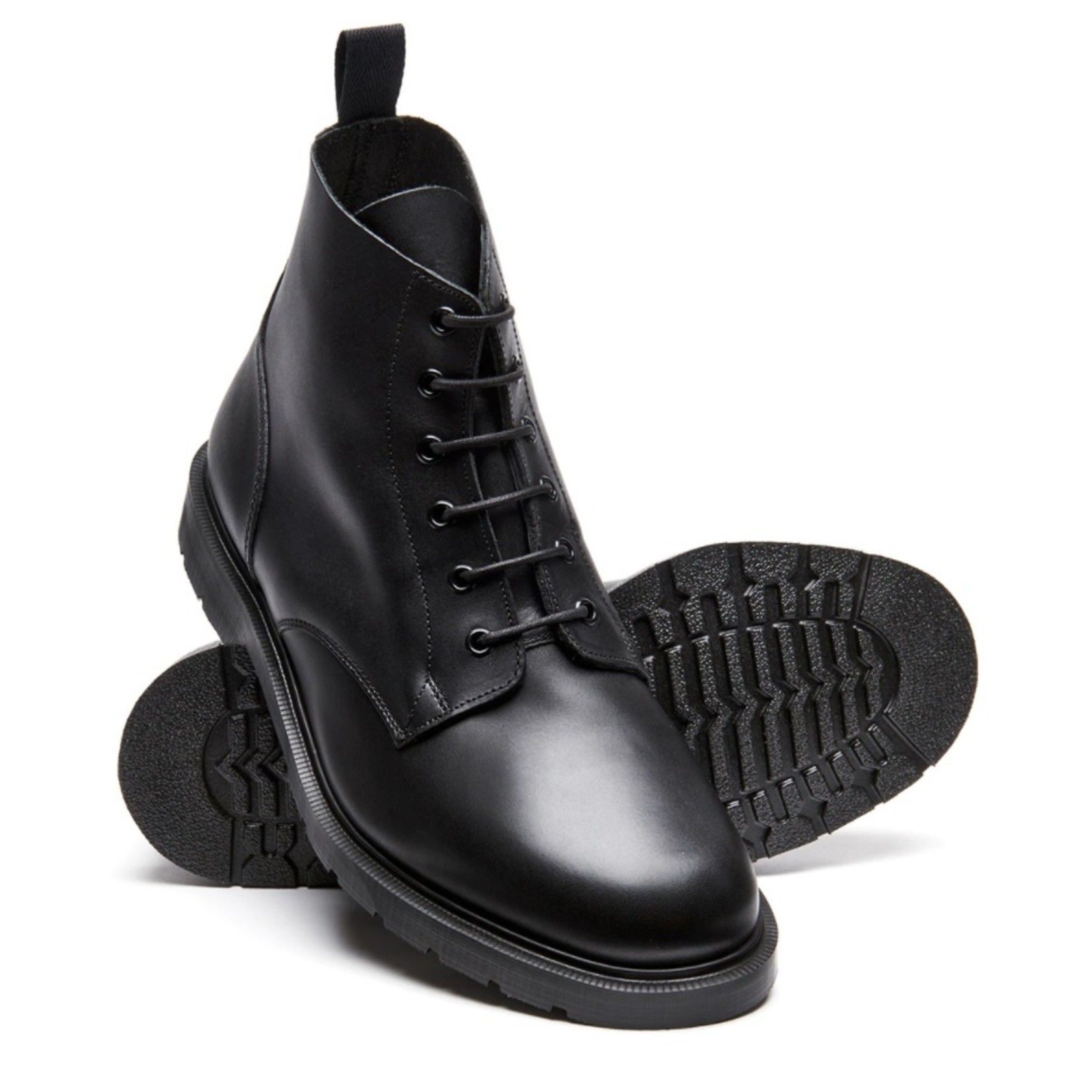 A pair of black boots are stacked on top of each other