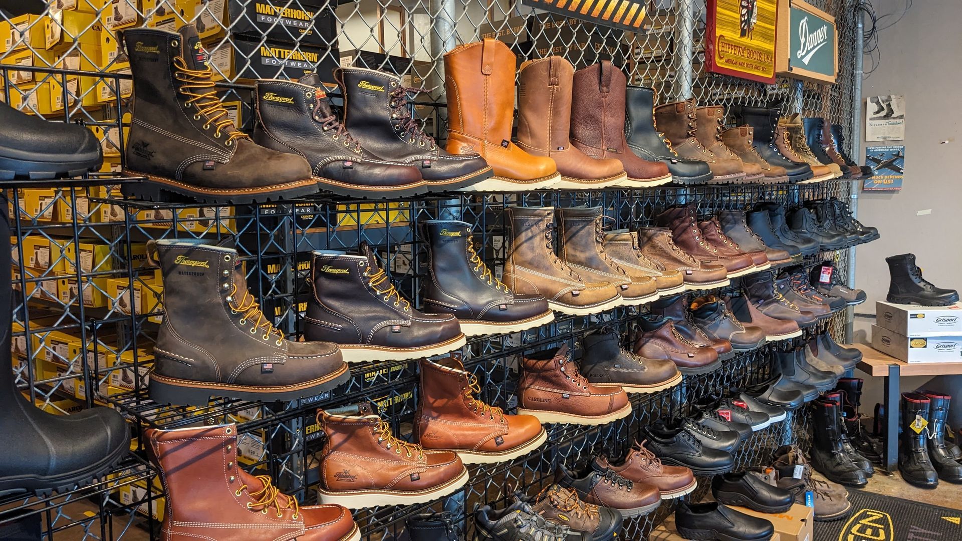 There are many different types of boots on display in this store.