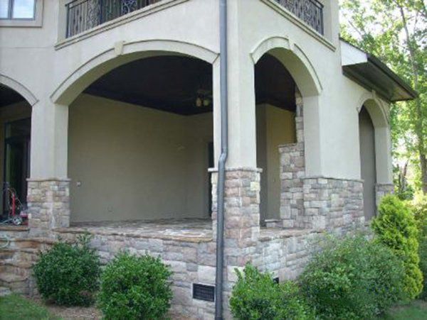 Covered porch with arches before screen enclosure