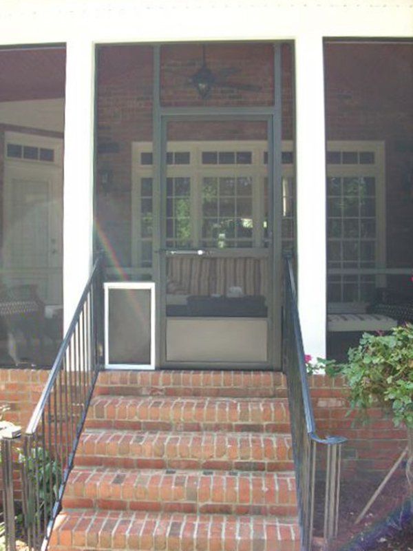 Pet door installed beside screen door