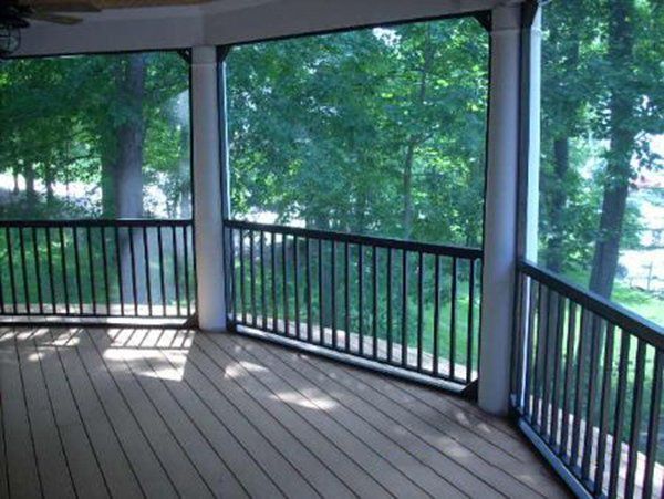 Bronze aluminum frame with rail and pickets against white round columns