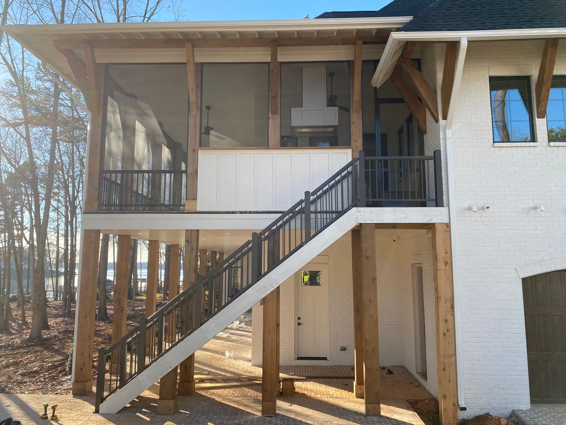 A white house with a screened in porch and stairs