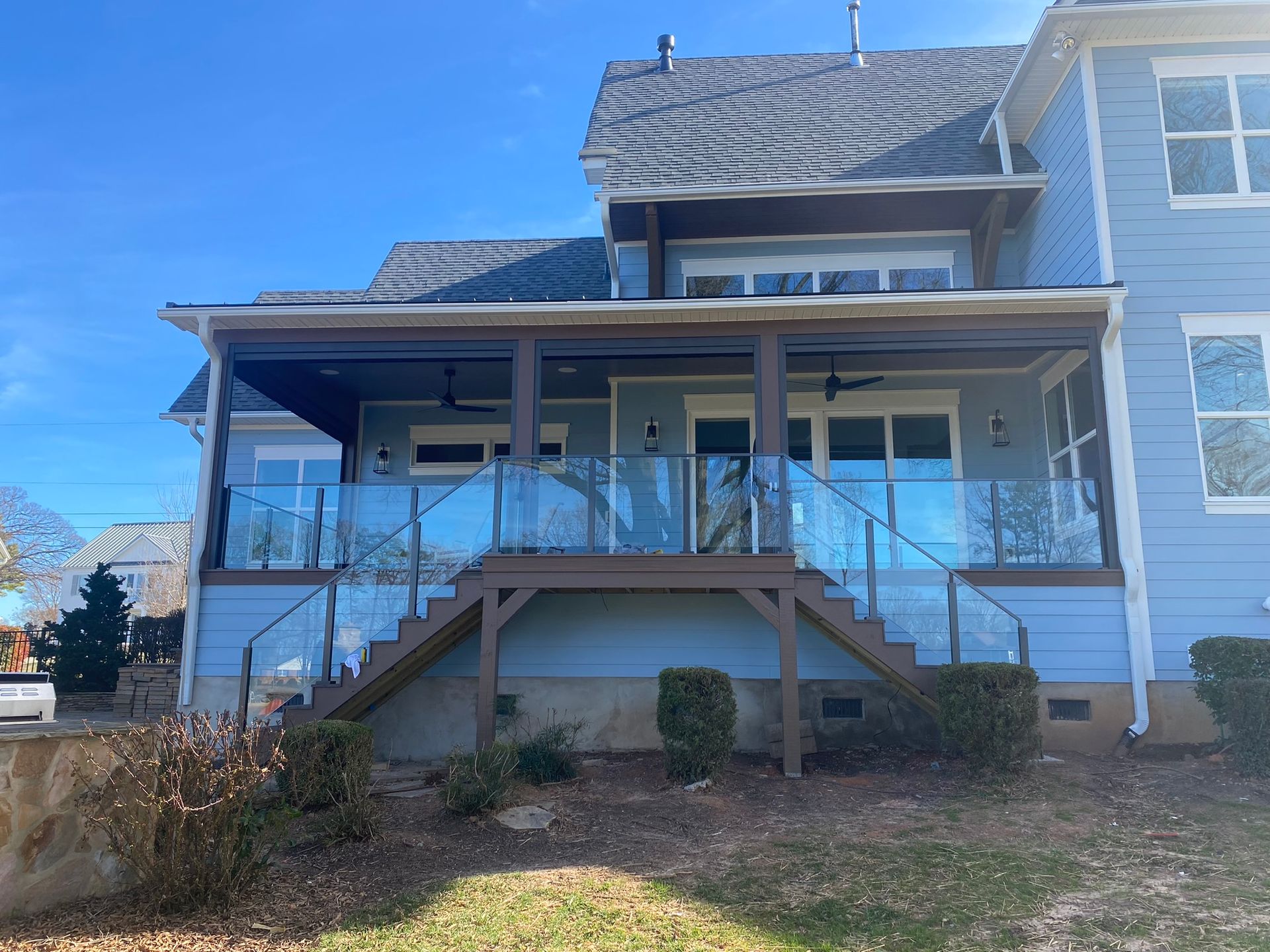 The back of a house with a large porch and stairs
