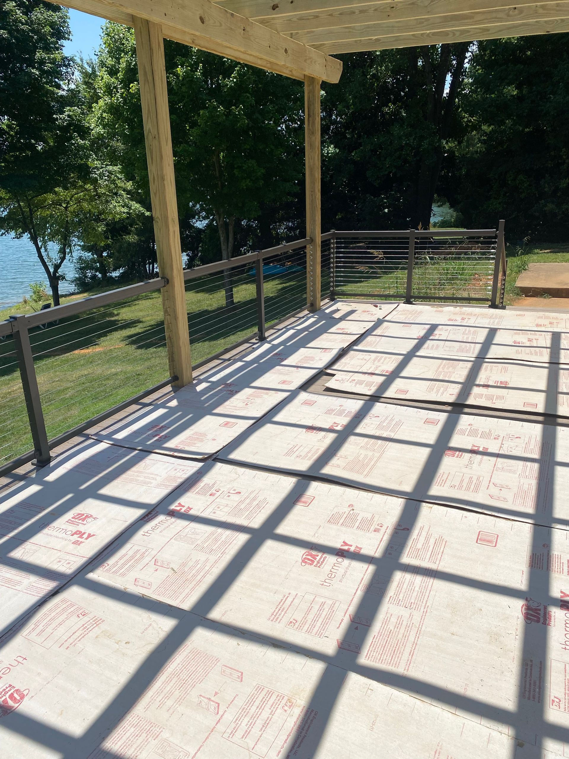 A patio with a pergola and cable railings.