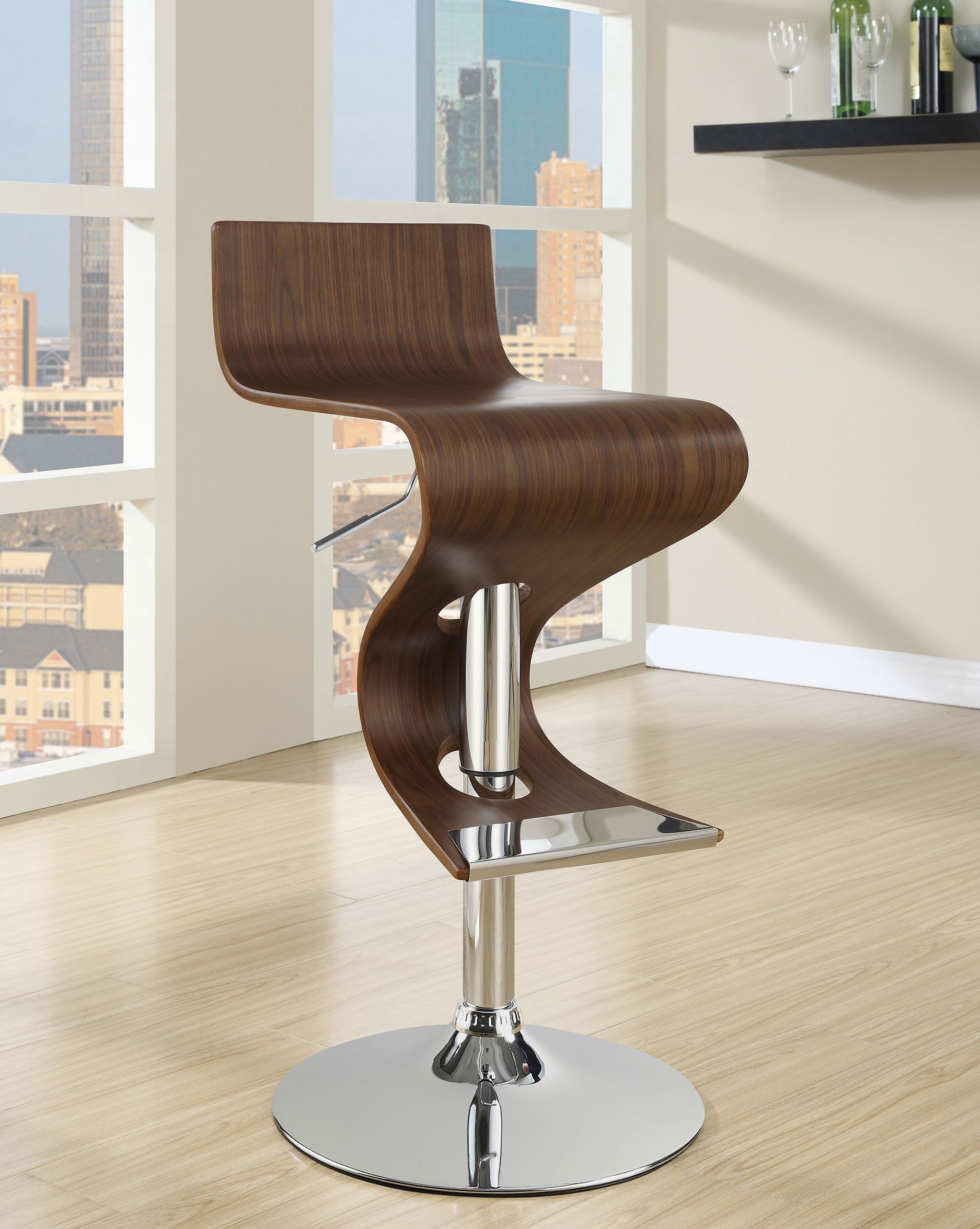 A wooden bar stool is sitting in front of a window