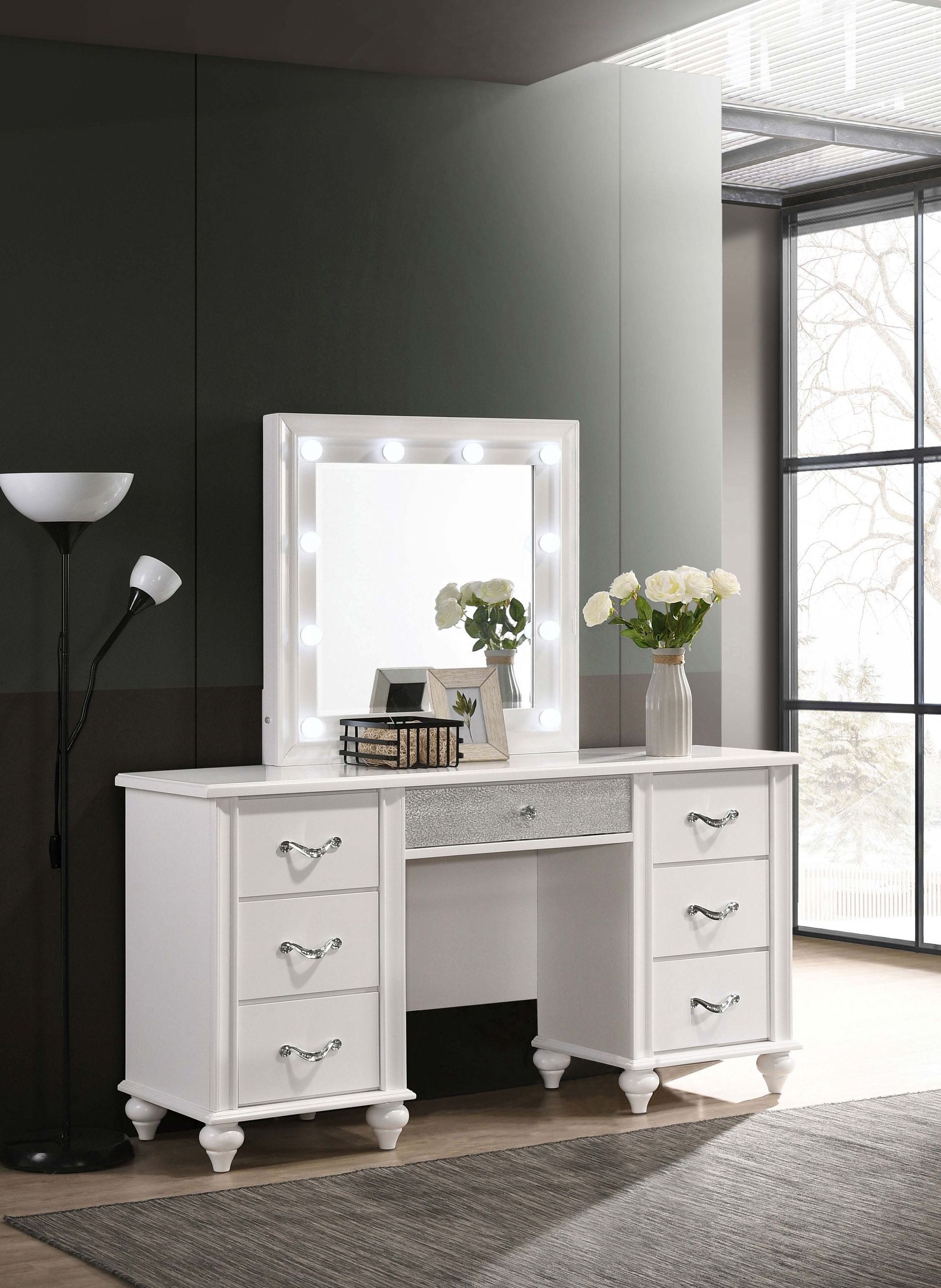 A white vanity with a mirror and lights in a bedroom.
