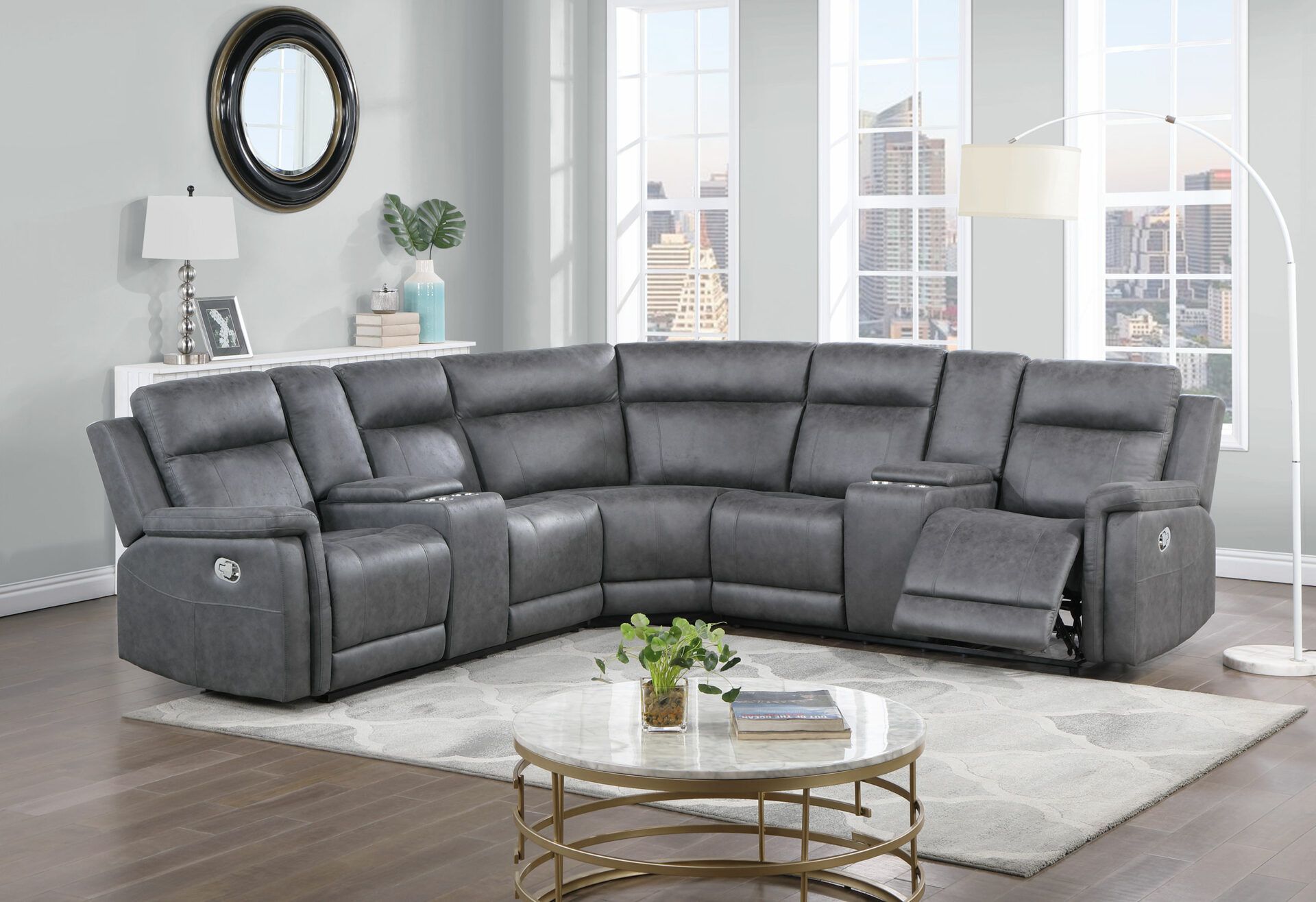 A living room with a gray sectional couch and a coffee table.