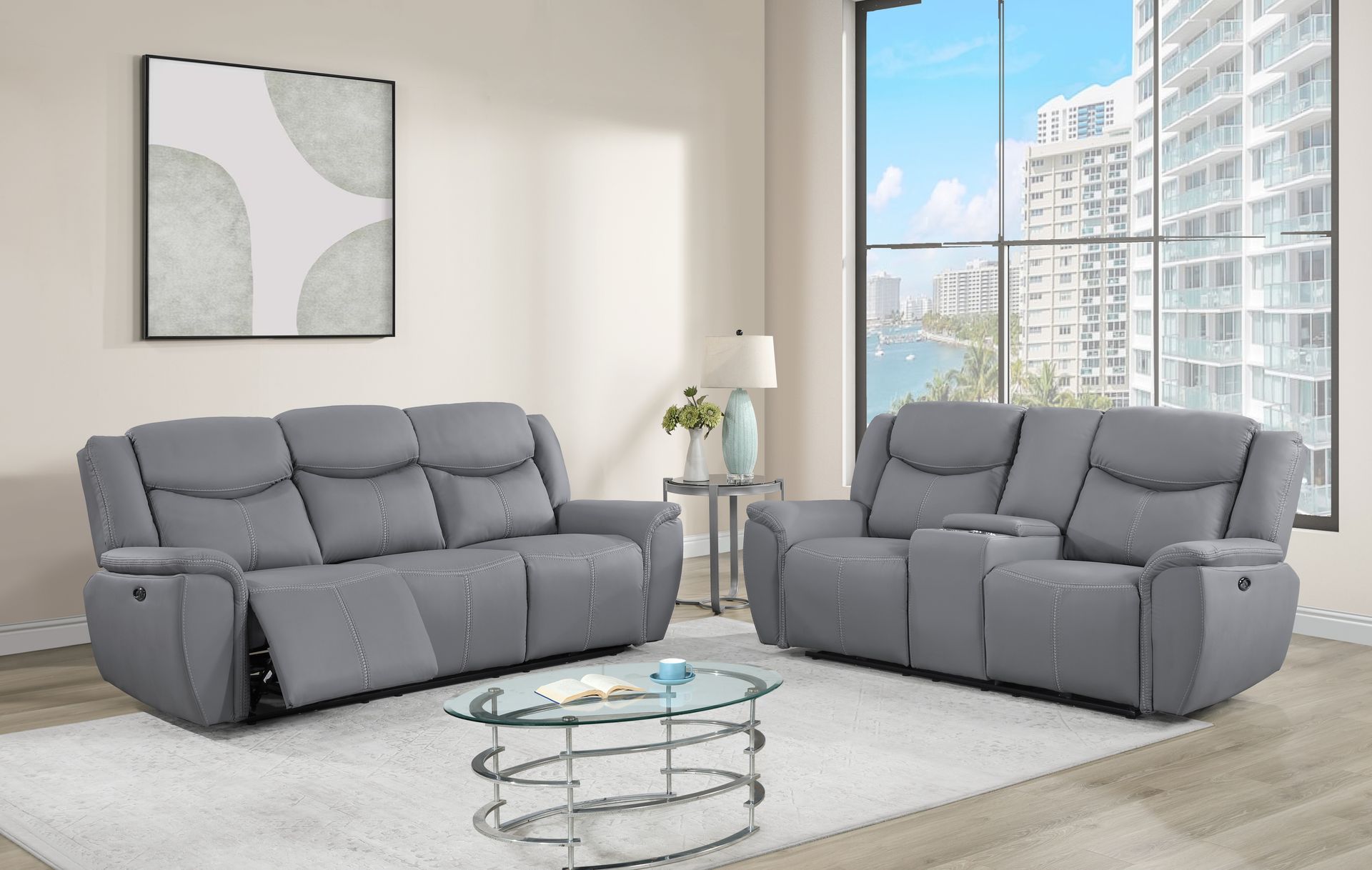 A living room with two grey couches and a glass coffee table.