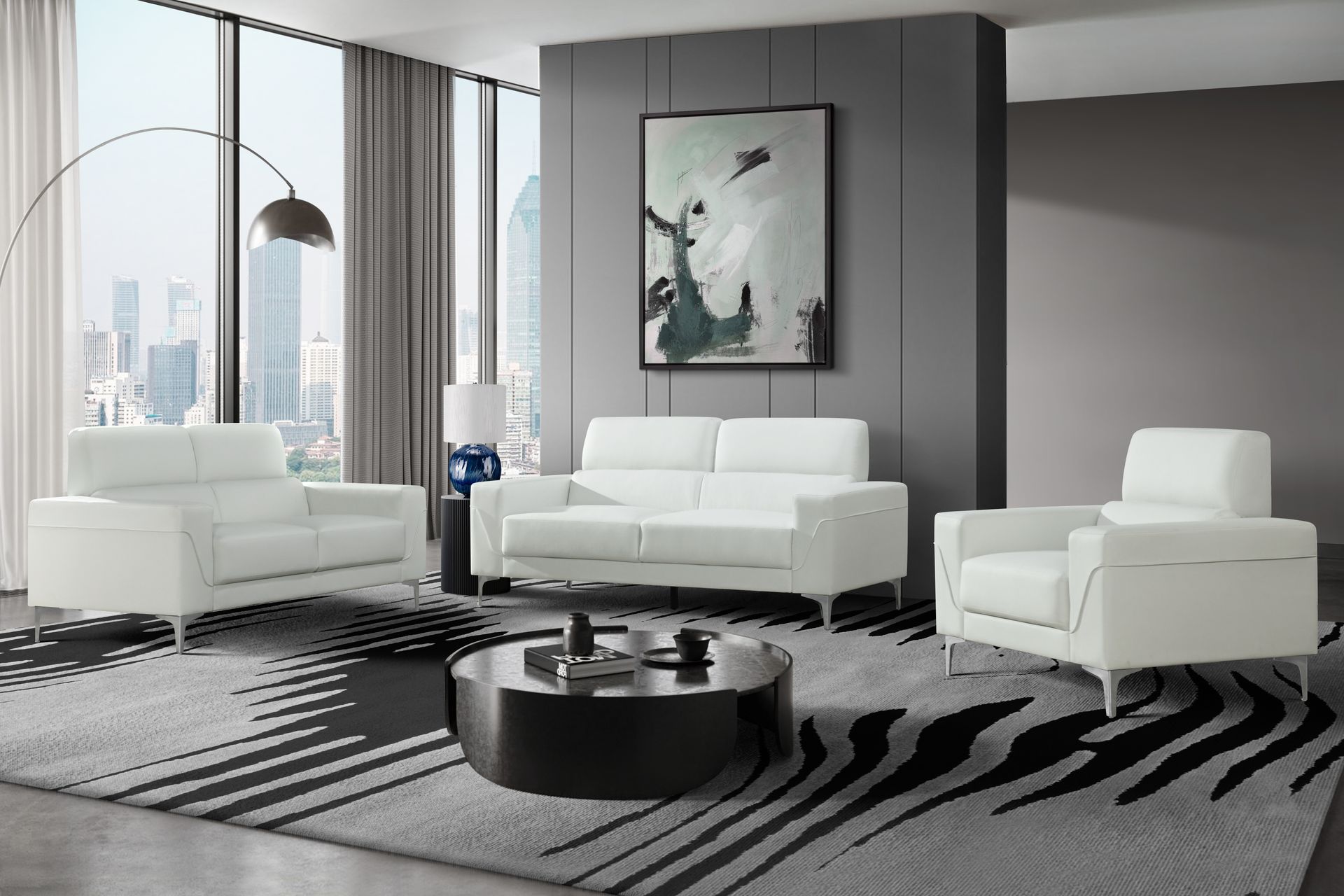 A living room with white furniture and a black and white rug.
