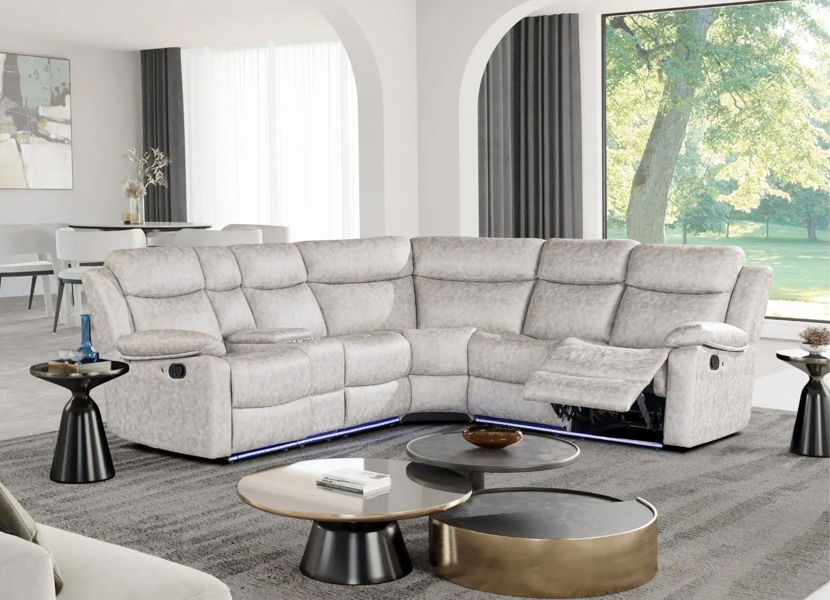 A living room with a white sectional couch and two coffee tables.