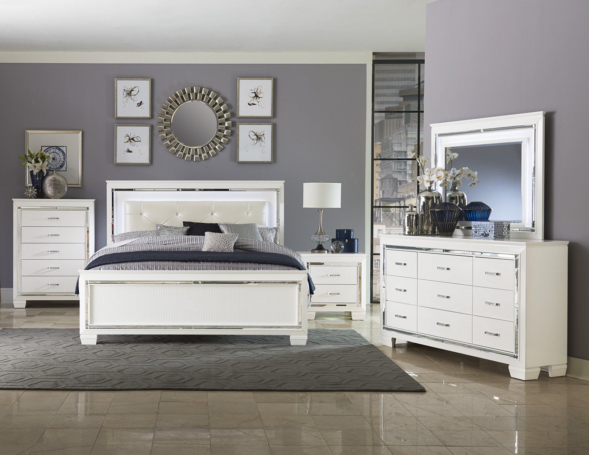 A bedroom with a bed , dresser , nightstand and mirror