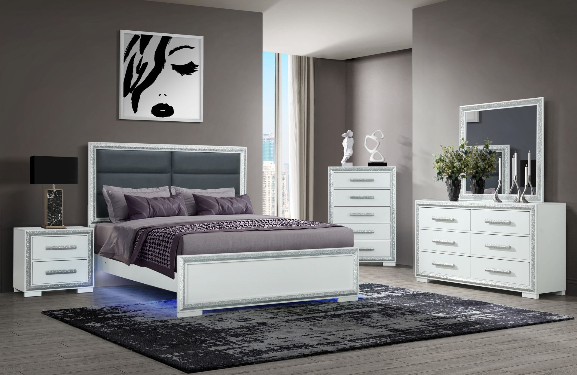 A bedroom with a bed , dresser , nightstand , mirror and chandelier.