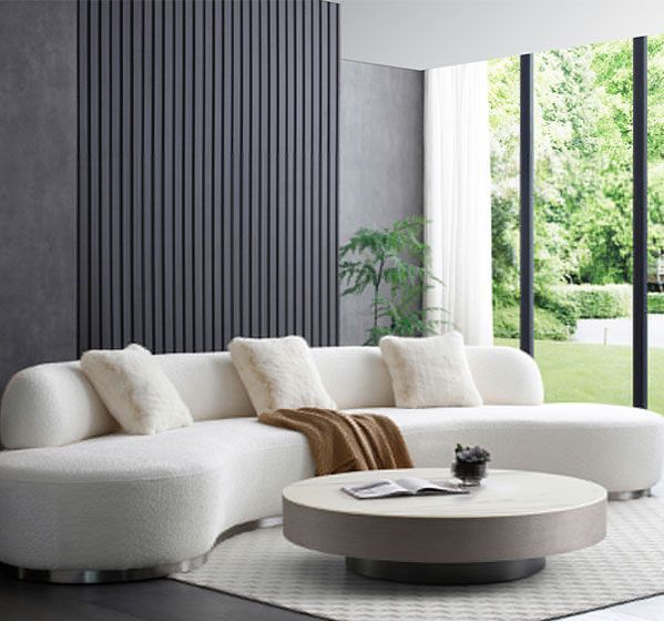 A living room with a white sectional couch and a coffee table.