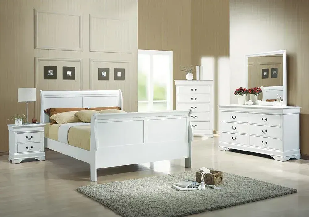 White bedroom set: sleigh bed, nightstand, chest, dresser, mirror, rug, with neutral walls.