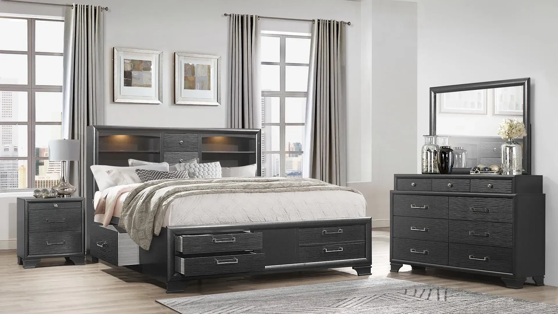 Bedroom set with gray bed, nightstand, dresser, and mirror in front of a window.