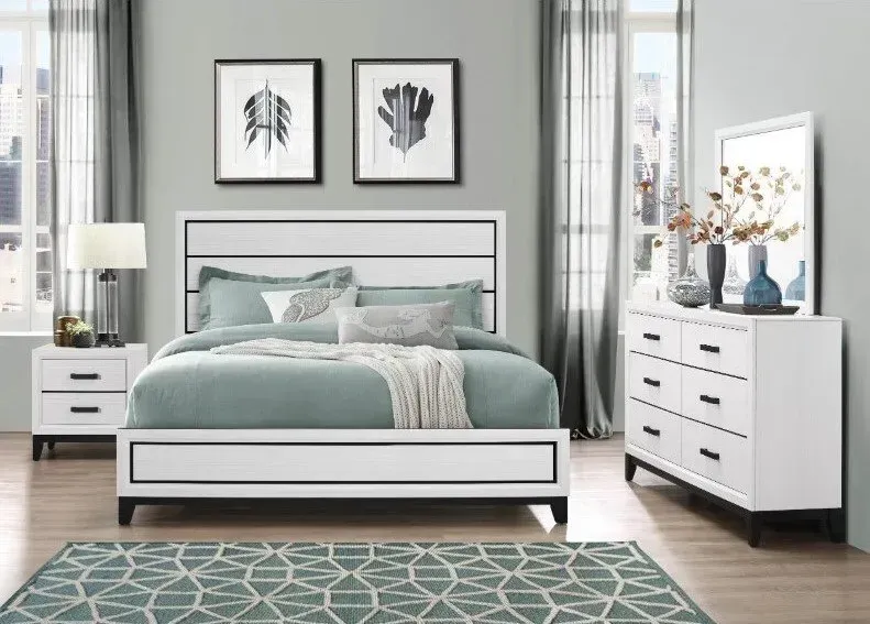 Bedroom set: white bed, dresser, and nightstand with black accents. Teal bedding, artwork, and rug.