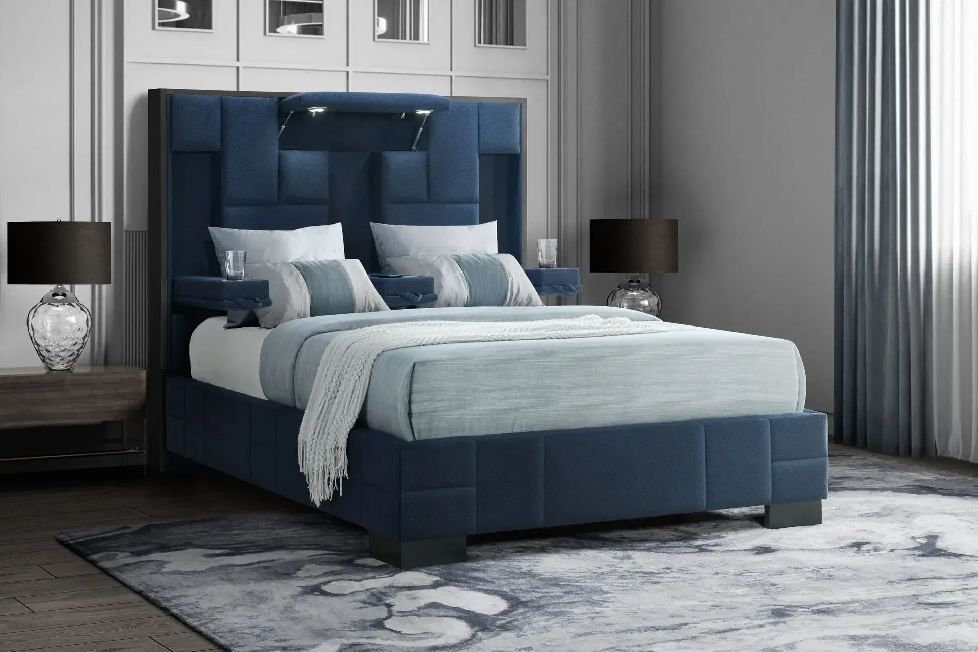 Blue upholstered bed in a bedroom setting with decorative pillows, two nightstands, and a patterned rug.