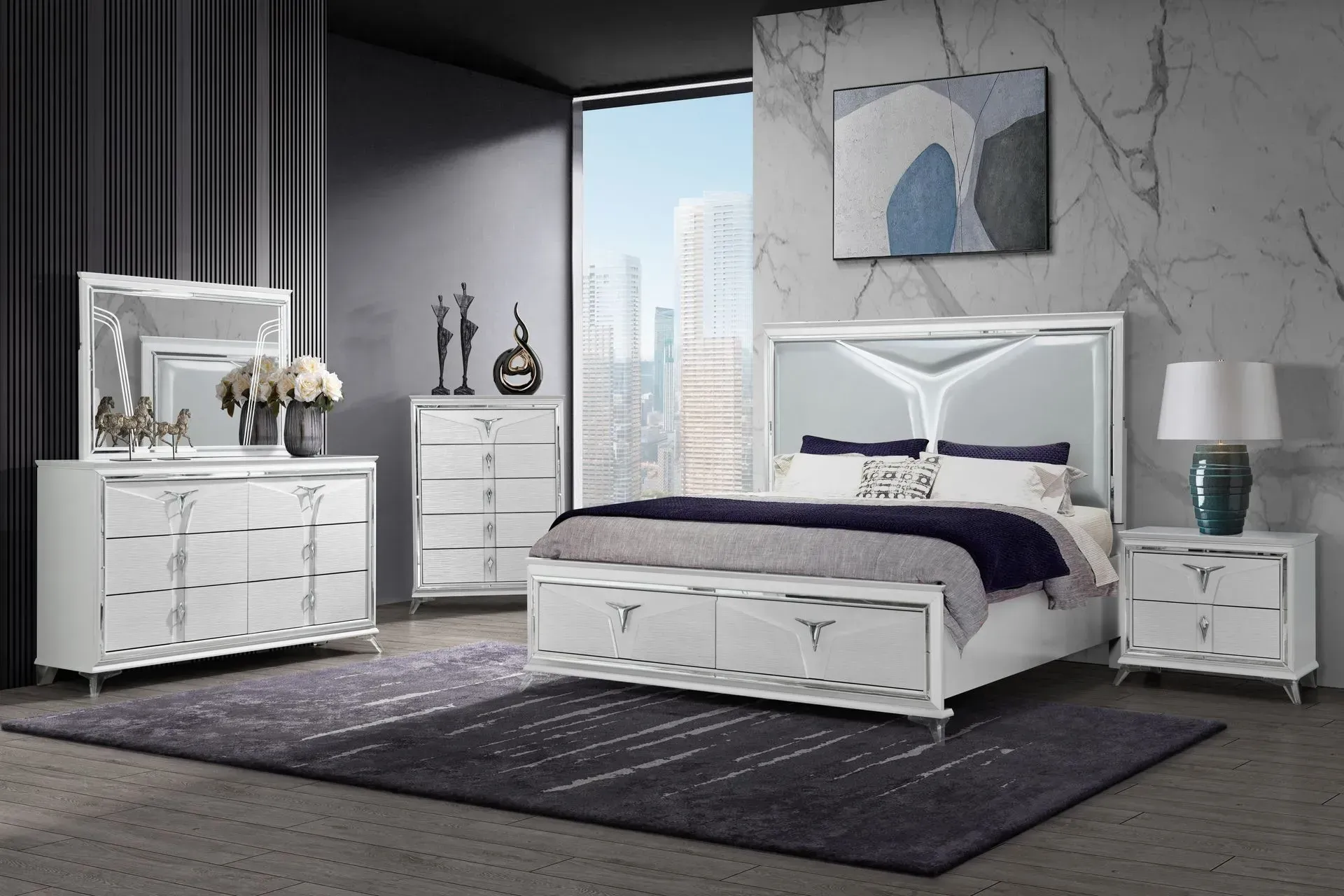 White bedroom furniture set with lit headboard, dresser, mirror, chest, nightstand, and bed. Grey rug.