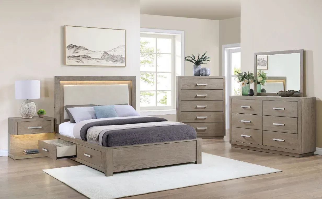 Bedroom set: light brown bed, nightstand, chest of drawers, dresser, and mirror in a room with a window and rug.